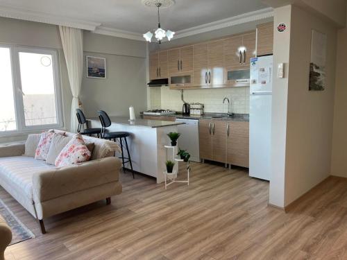 a living room with a couch and a kitchen at Yalova Apartments in Yalova