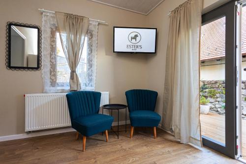 a waiting room with two blue chairs and a table at ESTER'S Szentbékkálla in Szentbékkálla