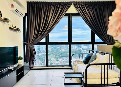 a bedroom with a bed and a large window at New 2BR or 3BR Cozy Urban Suite Homestay at Georgetown8-10pax by URBAN STAYCATIONS LOD in Jelutong