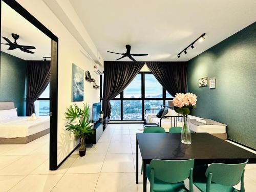 a room with a dining table and a bedroom at New 2BR or 3BR Cozy Urban Suite Homestay at Georgetown8-10pax by URBAN STAYCATIONS LOD in Jelutong