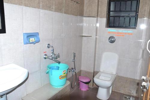 a bathroom with a toilet and a sink at RN Residency in Varanasi