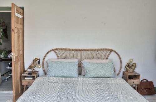 a bedroom with a bed with two blue pillows at The Rose Terrace - 2BD Home Kentish Town in London