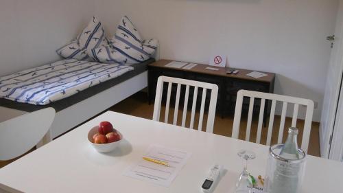 a room with a table with a bowl of fruit and a couch at Unseburger Brauhaus GmbH Ferienwohnung 2 in Unseburg
