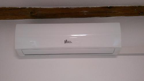 a white air conditioner hanging from a ceiling at Unseburger Brauhaus GmbH Ferienwohnung 2 in Unseburg