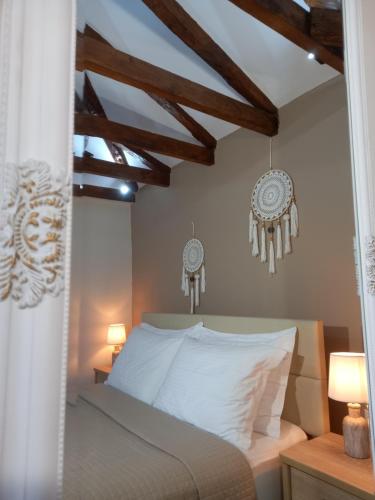 a bedroom with a white bed and two lamps at Panthea Residence in Theologos