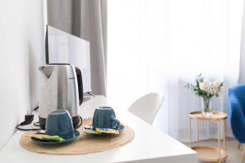 a coffee machine sitting on a table with mugs at L'Attimo Guesthouse in Verona