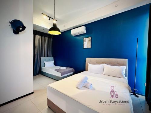a bedroom with a bed and a blue wall at New 2BR or 3BR Cozy Urban Suite Homestay at Georgetown8-10pax by URBAN STAYCATIONS LOD in Jelutong