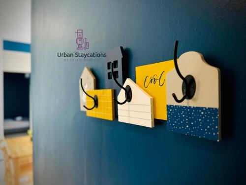a sign on a wall with headphones on it at New 2BR or 3BR Cozy Urban Suite Homestay at Georgetown8-10pax by URBAN STAYCATIONS LOD in Jelutong