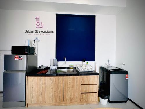 a kitchen with a sink and a refrigerator at New 2BR or 3BR Cozy Urban Suite Homestay at Georgetown8-10pax by URBAN STAYCATIONS LOD in Jelutong