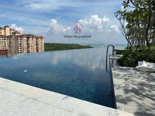 a swimming pool with a view of the water at New 2BR or 3BR Cozy Urban Suite Homestay at Georgetown8-10pax by URBAN STAYCATIONS LOD in Jelutong
