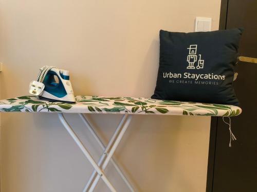 a bench with a pillow and a bag on it at New 2BR or 3BR Cozy Urban Suite Homestay at Georgetown8-10pax by URBAN STAYCATIONS LOD in Jelutong