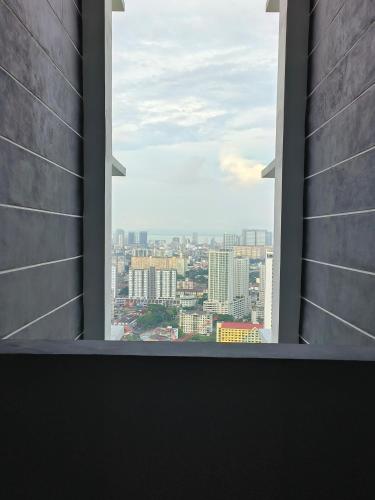 an open window with a view of a city at New 2BR or 3BR Cozy Urban Suite Homestay at Georgetown8-10pax by URBAN STAYCATIONS LOD in Jelutong