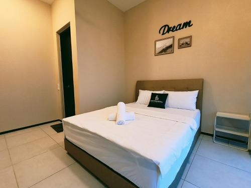 a hotel room with a bed with a demon sign on the wall at New 2BR or 3BR Cozy Urban Suite Homestay at Georgetown8-10pax by URBAN STAYCATIONS LOD in Jelutong