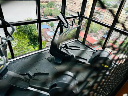 a view of a gym with two exercise bikes at New 2BR or 3BR Cozy Urban Suite Homestay at Georgetown8-10pax by URBAN STAYCATIONS LOD in Jelutong