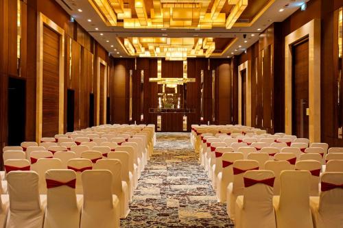 a large room with rows of chairs and a stage at Holiday Inn Chennai OMR IT Expressway by IHG in Chennai