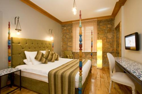 En eller flere senge i et værelse på Alp Pasa Hotel - Special Class