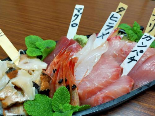 a plate of sushi with meat and vegetables on a table at Sado Ryosou Minato in Sado