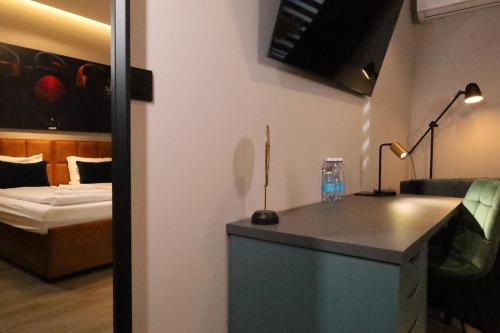 a room with a room with a bed and a desk at Comfort Hostel Klaipeda in Klaipėda