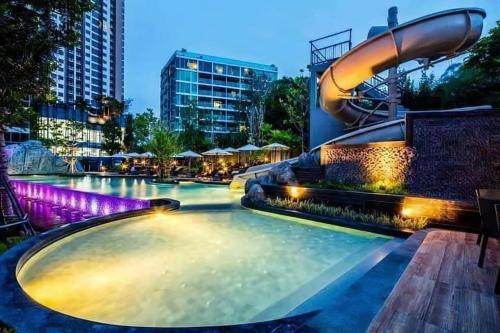a swimming pool with a water slide in a building at unixx seaview in Pattaya South