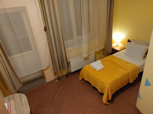 a hotel room with a bed and a window at Arsenal in Daugavpils