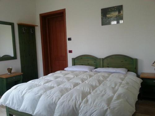 a bedroom with a large white bed with two pillows at RESIDENCE LA VECCHIA REGGIO in Reggio Emilia