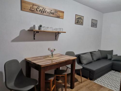 a living room with a table and a couch at Dió vendégház in Praid