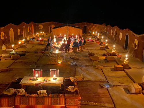 a group of people standing in a street at night at Camp Desert Bivouac Chegaga in El Gouera