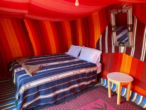 a room with a bed in a circus tent at Camp Desert Bivouac Chegaga in El Gouera