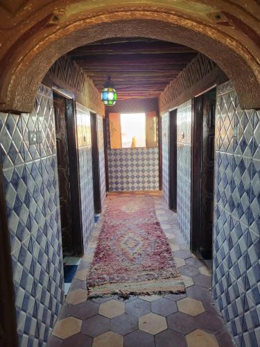 a hallway in a house with a tile floor at Camp Desert Bivouac Chegaga in El Gouera