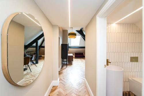 un couloir avec un miroir et une salle à manger dans l'établissement The Sky Lodge & Penthouse Apartments at Hillthorpe Manor by Maison Parfaite - Wentbridge, à East Hardwick