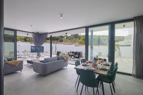 a living room with a table and chairs and a couch at Elite Pearl Villas in Protaras
