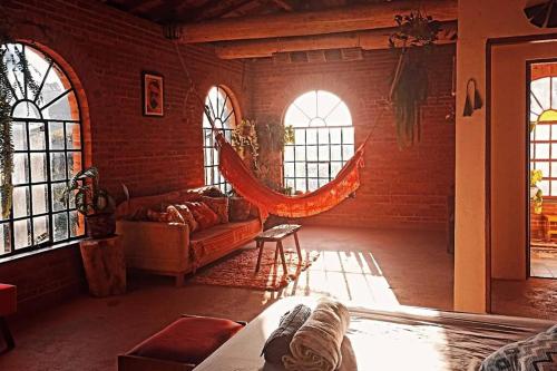 a living room with a couch and some windows at Casa rústica cercada de natureza em Atibaia in Atibaia