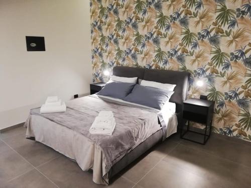 a bedroom with a bed and a wall with aarijuana at Le Case di Rita in Naples