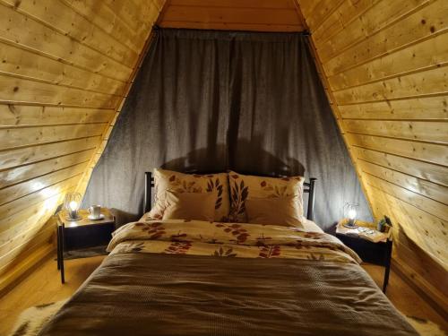 Stara SušicaにあるGorska bajka - Tisa, planinska kuća za odmor i wellnessの木製の天井のベッドルーム1室(ベッド1台付)