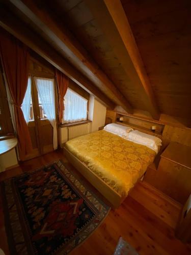 Ένα ή περισσότερα κρεβάτια σε δωμάτιο στο Chalet Panorama Dolomiti