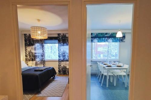 1 dormitorio con 1 cama y comedor con mesa en Spacious apartment with balcony and free WiFi, en Rovaniemi