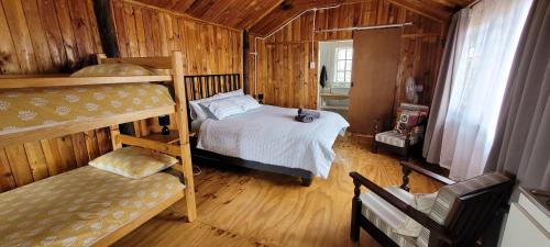 a bedroom with two bunk beds in a cabin at Soetdorings Farmstay Karoo Chalet in Beaufort West