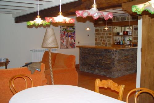a living room with a couch and a table at Casa del Lago de Campoo in Orzales