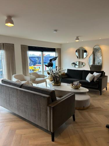 a living room with a couch and a table at Bij de Haven op Urk in Urk