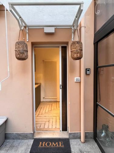 a hallway leading into a home with two pendant lights at Roma Caracalla apartament with garden in Rome