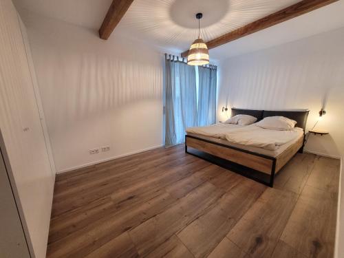 a bedroom with a bed and a large window at Ferienwohnung am Ohmbachsee in Gries