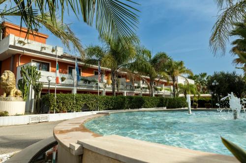 a swimming pool in front of a hotel at Prince Franklyn Hotel in Santa Maria di Castellabate