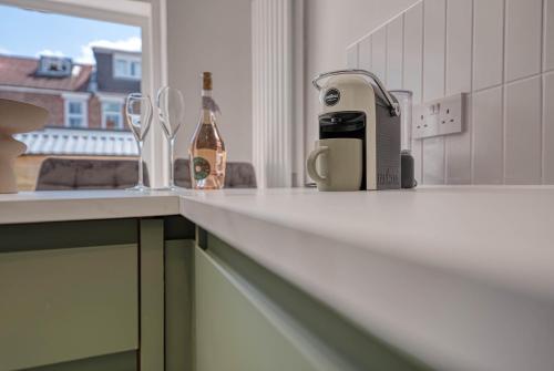a kitchen counter with a bottle of wine and a toaster at Modern Townhouse 3-BR, Sleeps 8, Central Location by Blue Puffin Stays in Portsmouth