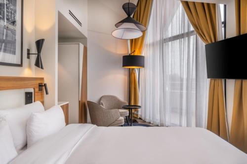 a hotel room with a bed and a window at Radisson Blu Grand Hotel & Spa, Malo-Les-Bains in Dunkerque