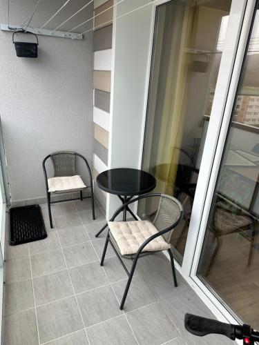 a small balcony with a table and chairs on it at Stratený kľúč in Revúca