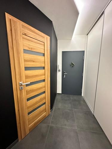a hallway with a wooden door and a room at Stratený kľúč in Revúca