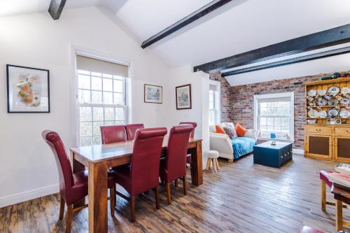 a dining room and living room with a table and chairs at Stunning 4-bedroom Country House with Canal Views in Sandbach by HP Accommodation in Sandbach