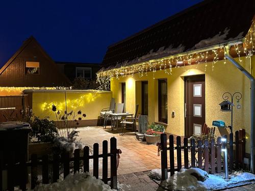 a house with christmas lights on the side of it at Gasthaus Wini in Wanzleben