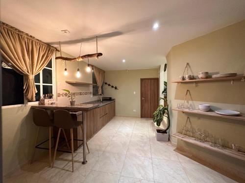 a kitchen with a island in the middle of a room at Casa de Ali in Pereira