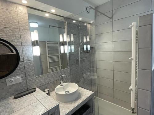 a bathroom with a sink and a shower and a mirror at Appartement 2 pièces pour 4 pers avec balcon à l'Alpe d'Huez - FR-1-405-227 in LʼHuez